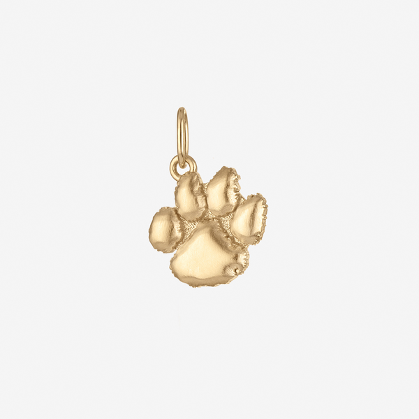 Gold paw print charm on a white background