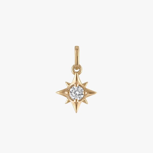 Gold star-shaped pendant with a diamond on a light gray background