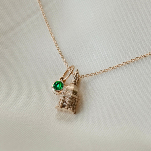 Notre Dame Golden Dome Pendant shown in gold on Cable Chain with Emerald Gemstone laydown