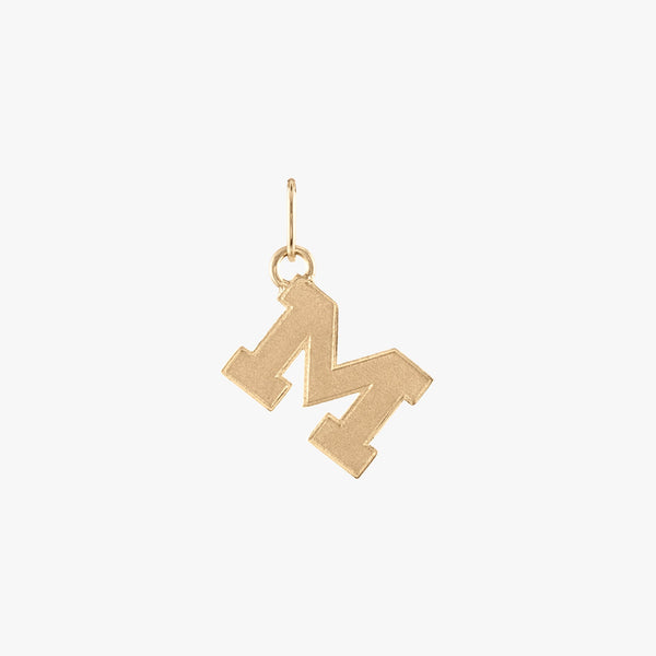 A gold Michigan M letter charm with a satin finish.