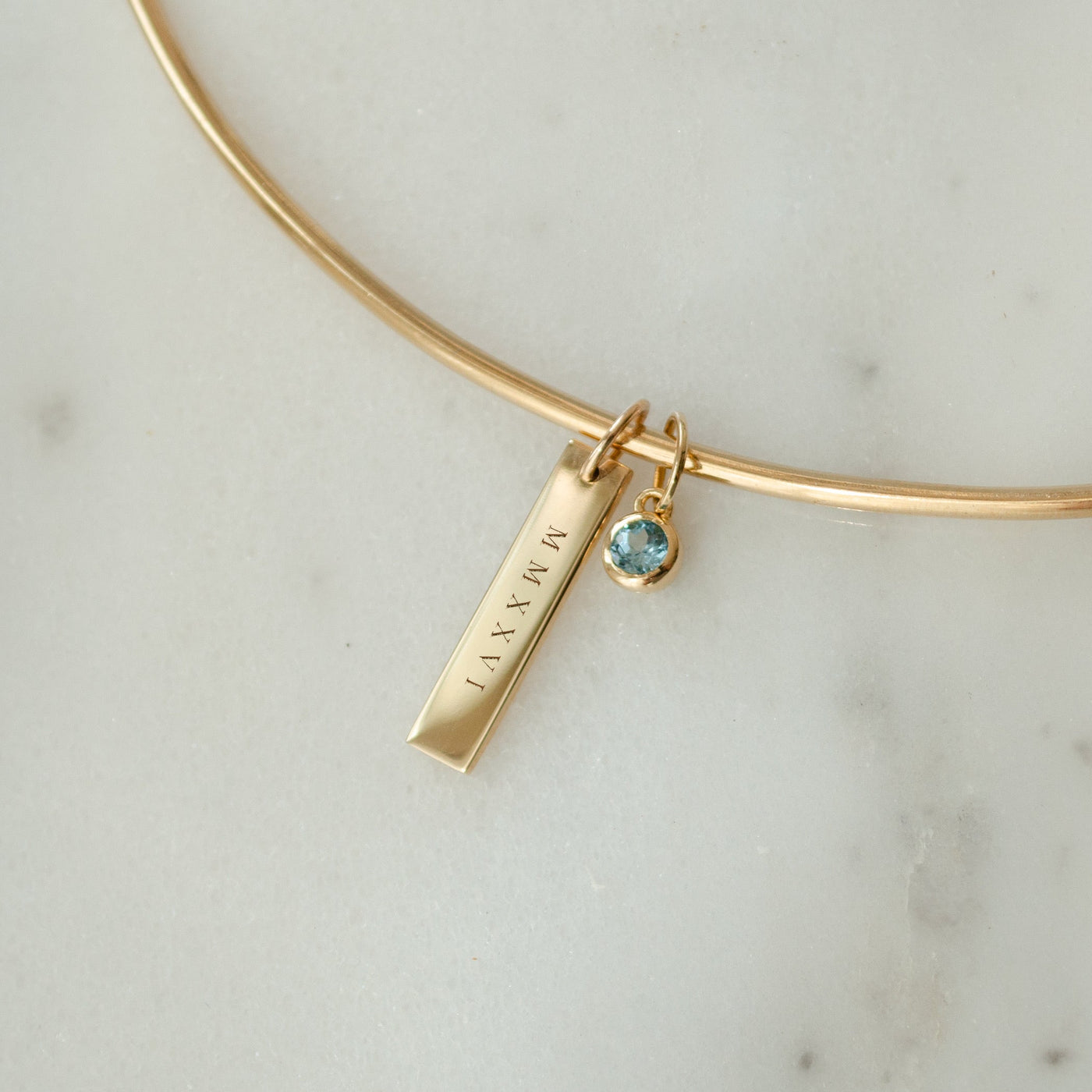 2026 Grad Layering Bar shown on Neck Collar with Blue Topaz Gemstone in gold