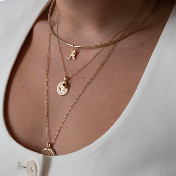 Alabama Logo Charm shown on figure in gold on Neck Collar, with Alabama Sunburst Bundle on Cable Chain