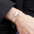 Alpha Delta Pi Bracelet Bundle shown on figure in gold with Blue Topaz Gemstone Bracelet