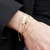 Alpha Epsilon Phi Bar Bracelet shown on figure in gold with Emerald Gemstone Bracelet