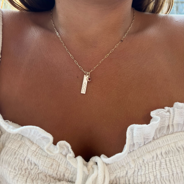 Alpha Omicron Pi Bar Bundle shown on figure in gold