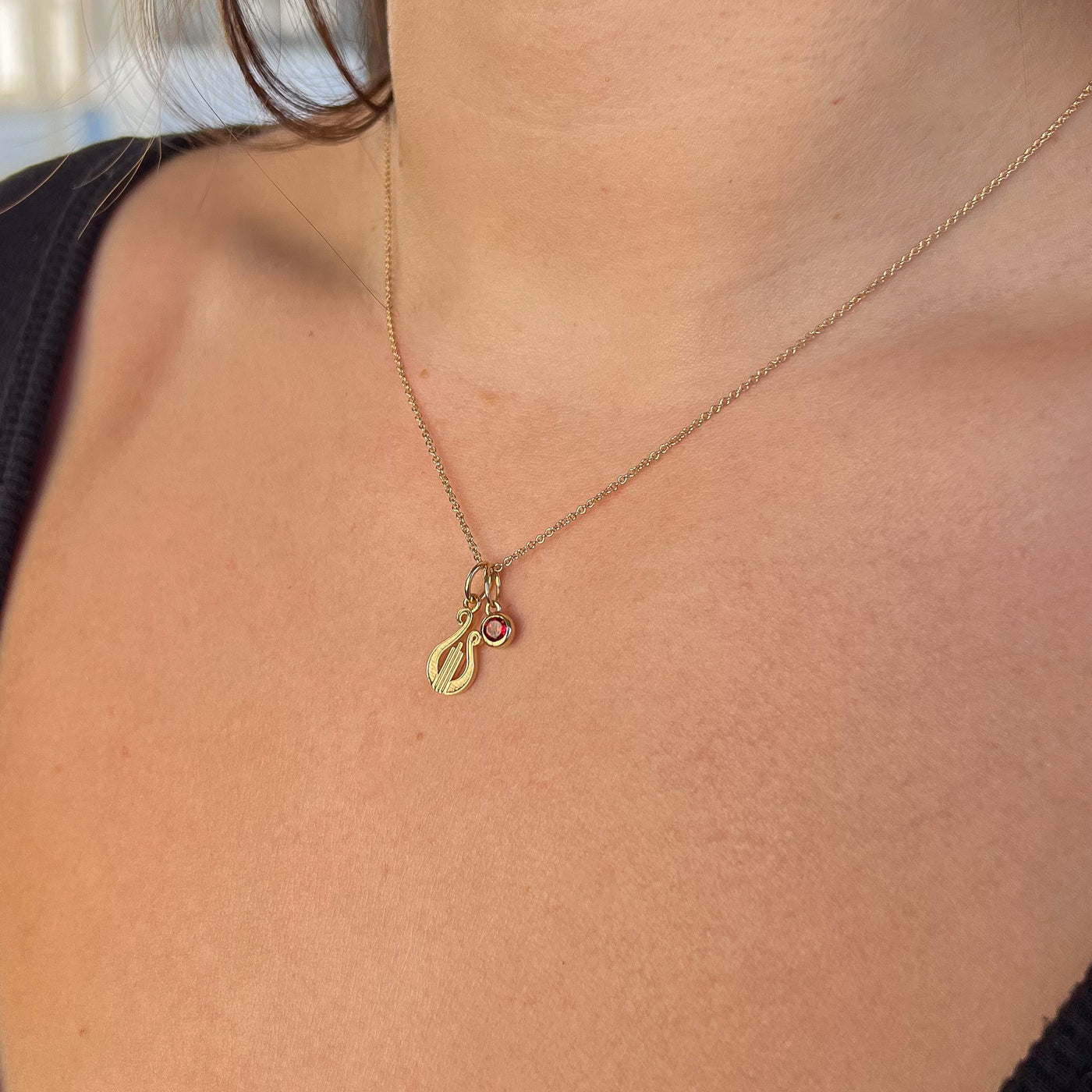 Alpha Chi Omega Lyre Charm Bundle shown on figure in gold