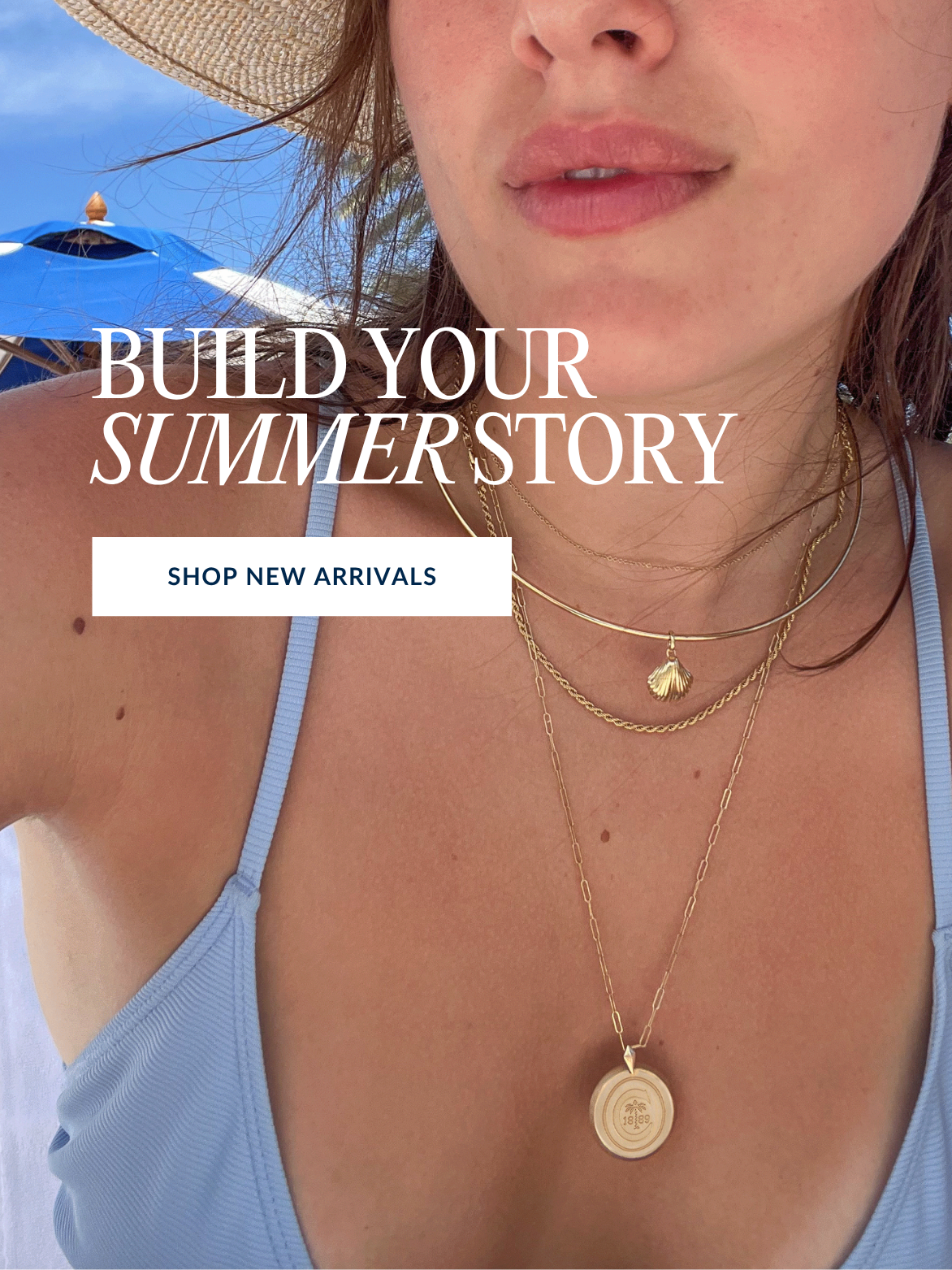 Woman wearing gold necklaces with a beach umbrella and blue sky in the background, text overlay 'Build Your Summer Story'.