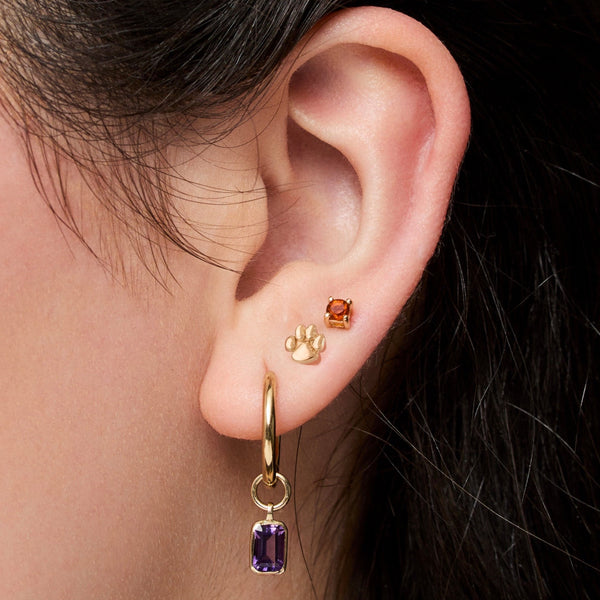 Clemson Paw Stud shown on figure in gold with Citrine Stud Earring and Amethyst Earring Charm