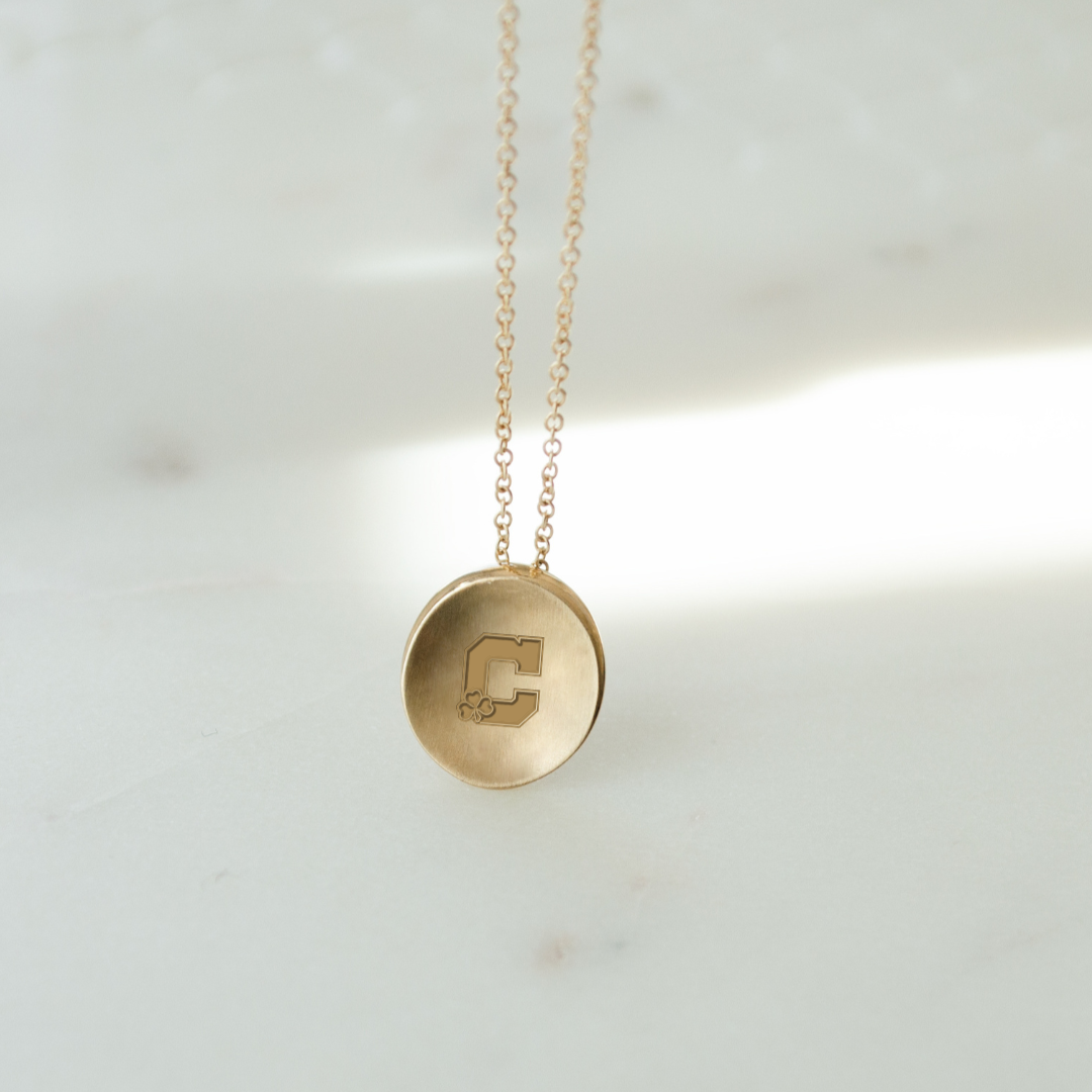 Cathedral Logo Necklace shown in gold