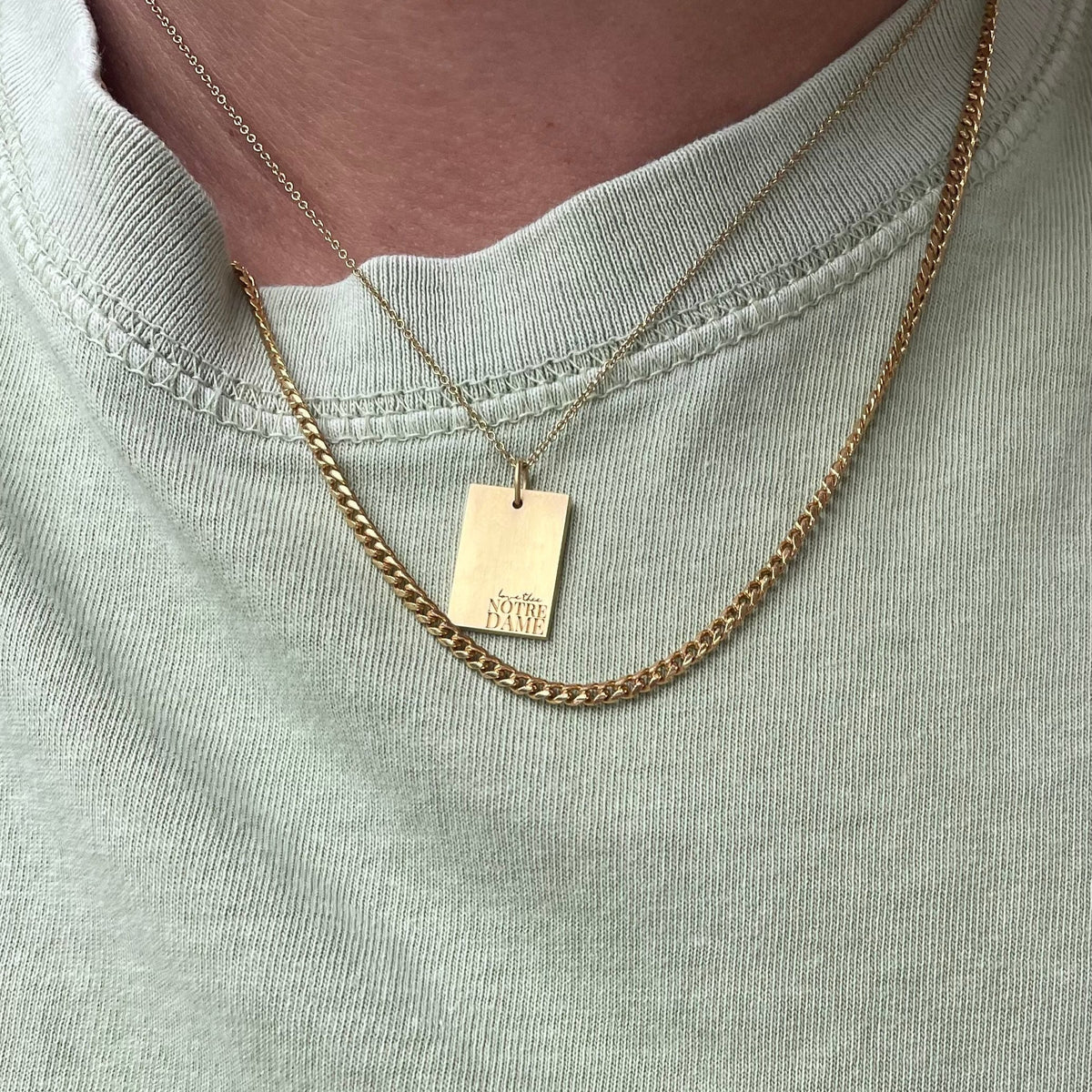 Notre Dame Rectangle Pendant shown on figure in gold on Cable Chain