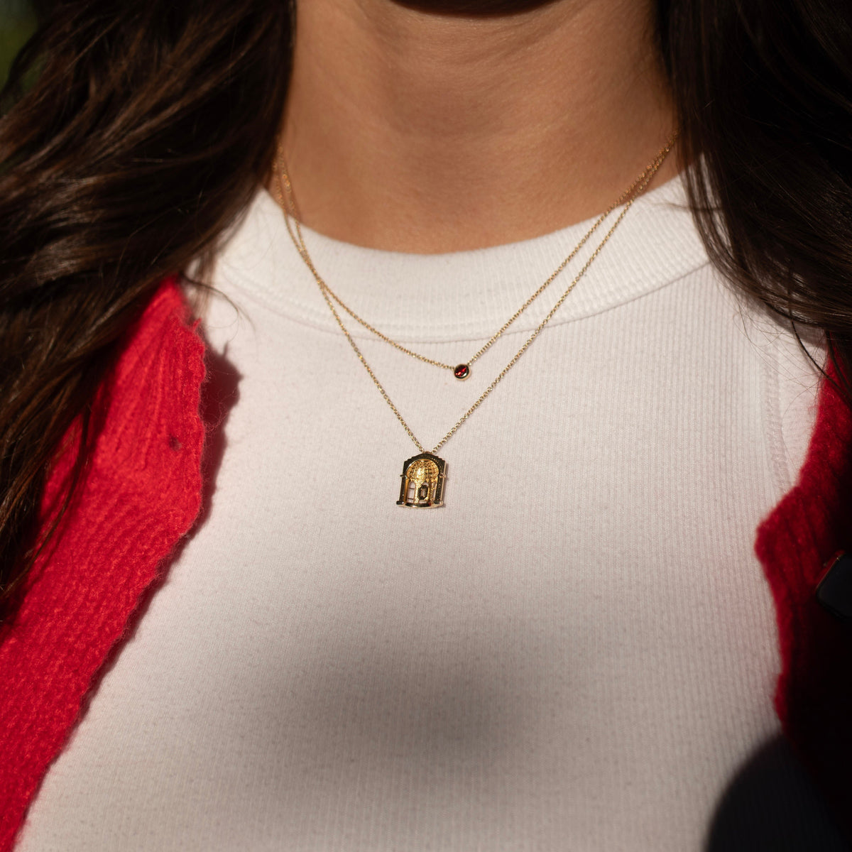 Ohio State Stadium Rotunda Pendant shown on figure in gold on Cable Chain with Garnet Gemstone Necklace