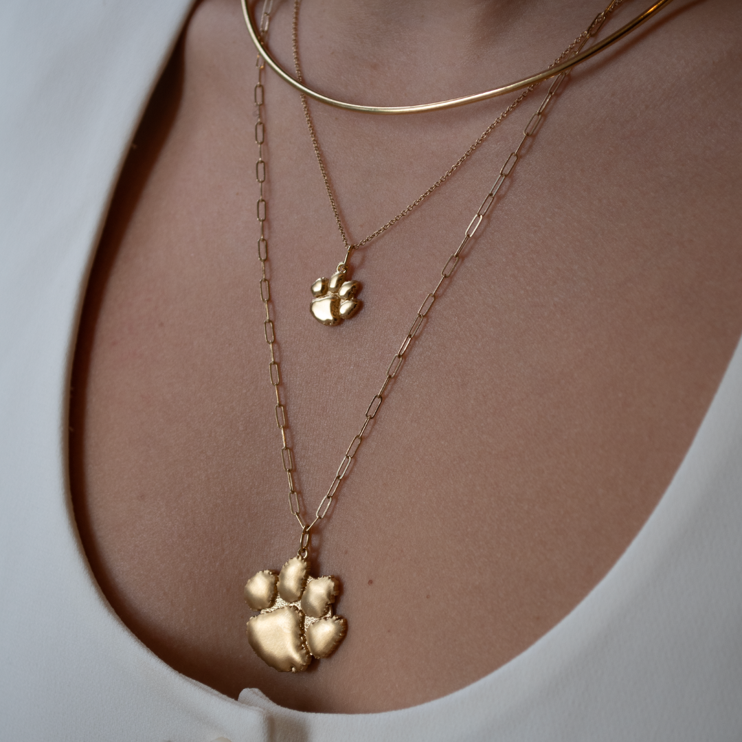 Clemson Paw Charms in both sizes shown on figure in gold with Neck Collar in gold