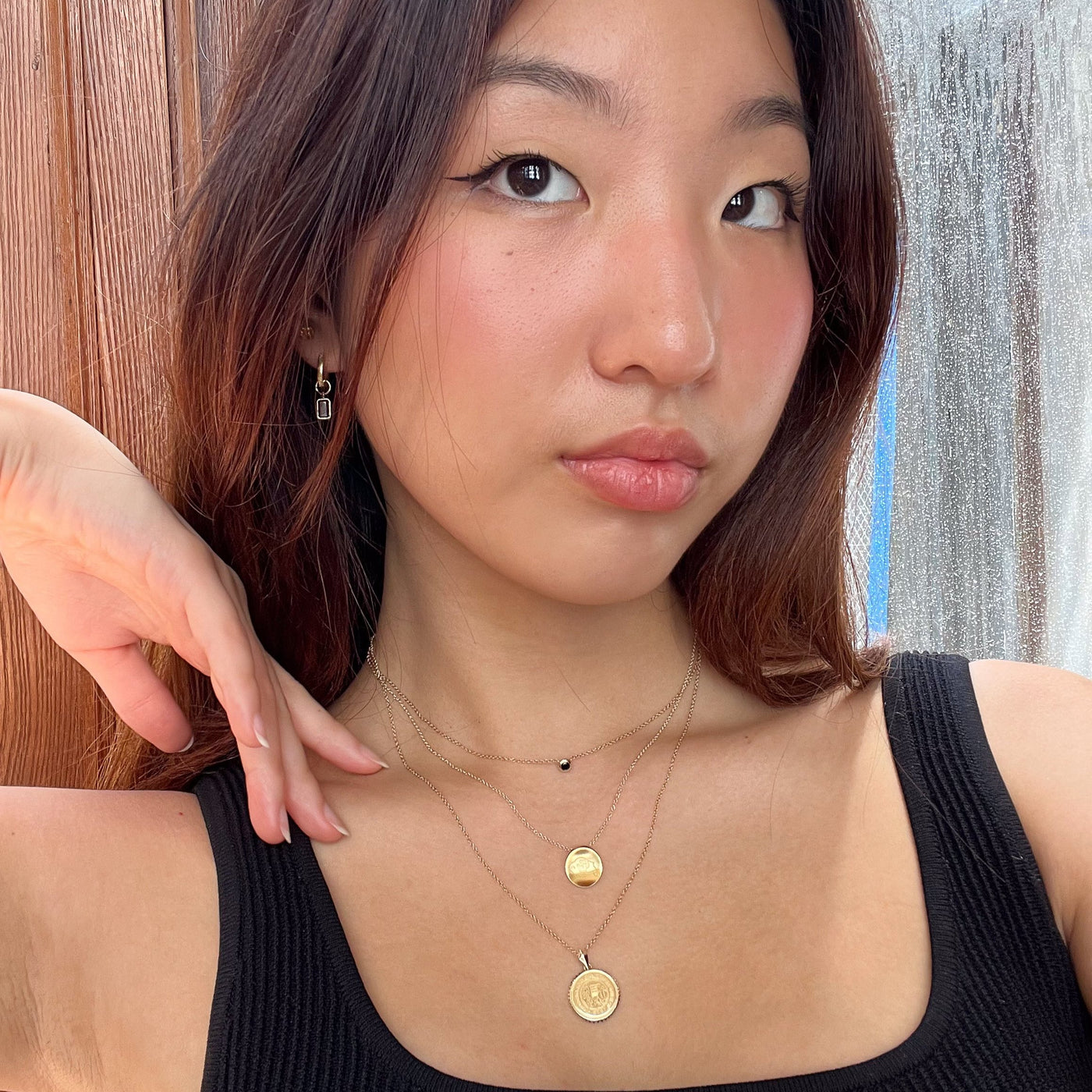 Colorado Sunburst Necklace shown on figure in gold on Cable Chain with Colorado CU Necklace in gold and Black Onyx Gemstone Necklace