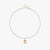 A delicate light blue beaded necklace with a small gold birdcage pendant, displayed on a clean white background.