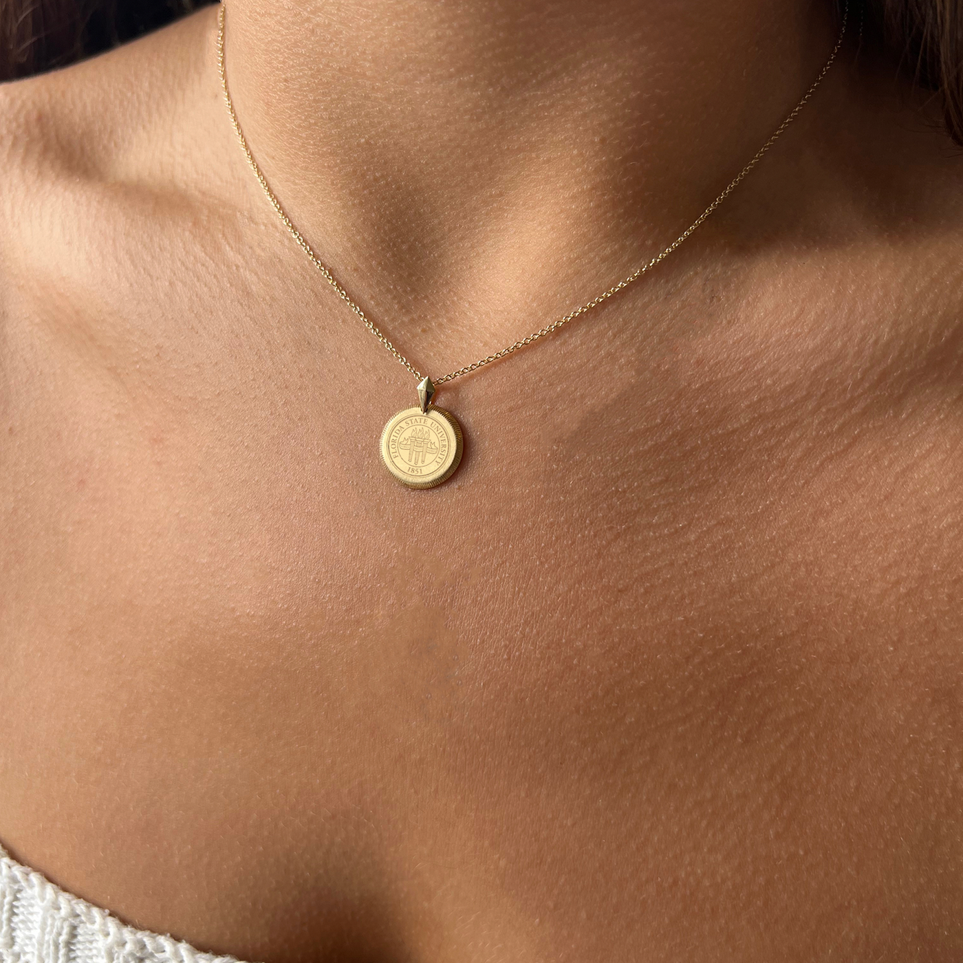 FSU Florentine Pendant shown on figure in gold in Petite size on Cable Chain