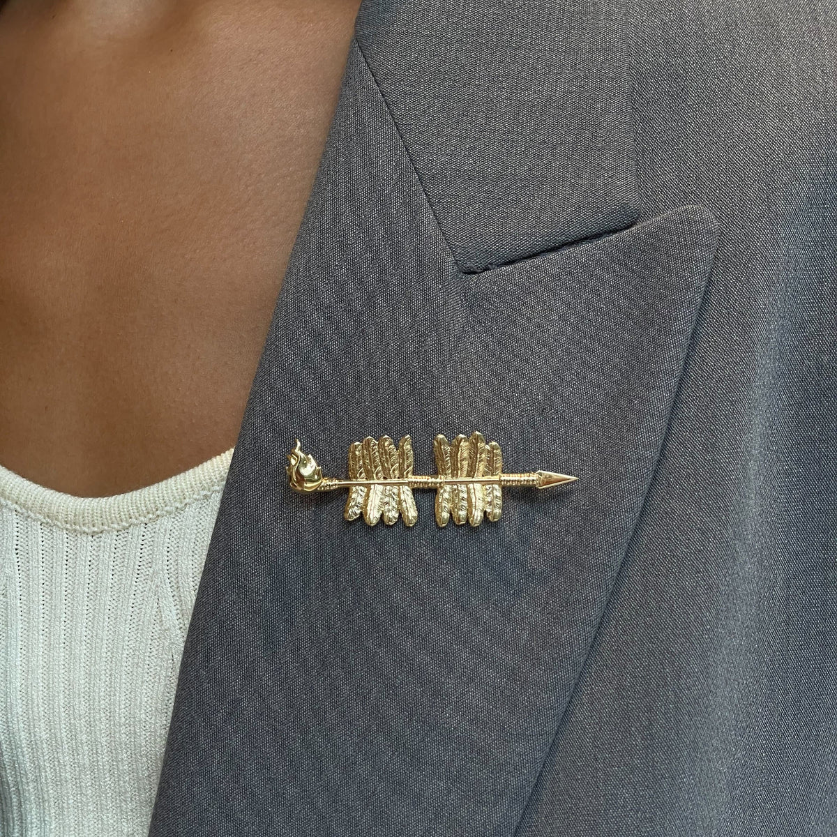 FSU Spear Lapel Pin shown on figure in gold
