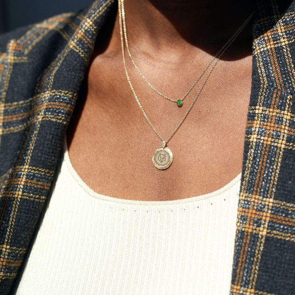 Georgetown Visitation 7-Point Diamond Necklace shown on figure with Emerald Gemstone Necklace