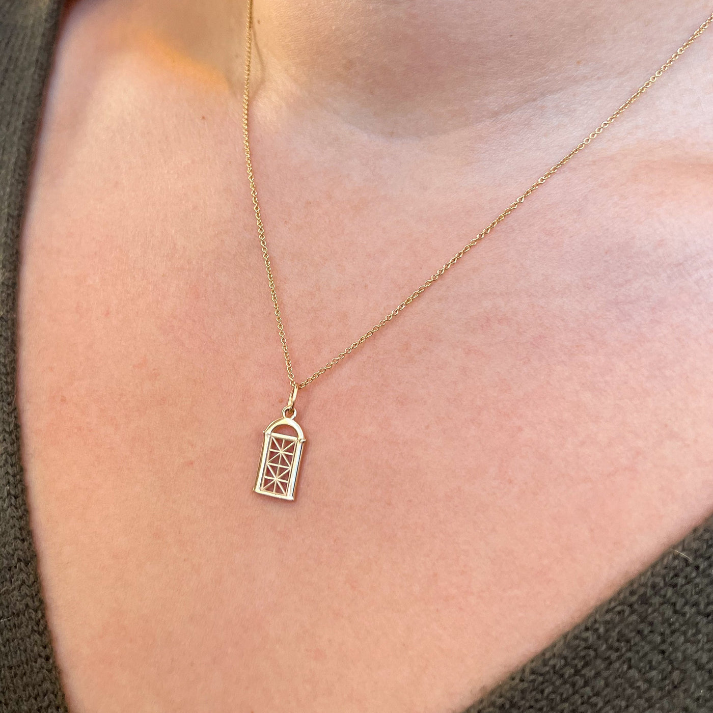 Georgetown Visitation Gate Small Pendant shown on figure in gold on Cable Chain