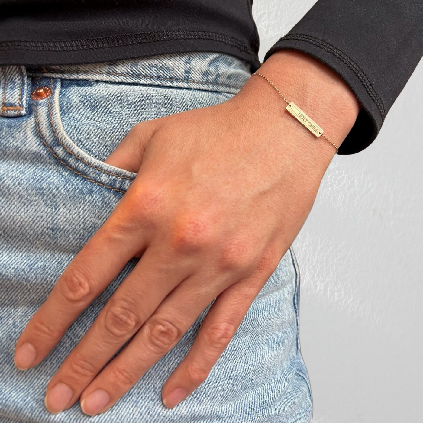 Holy Child Bracelet shown on figure in gold