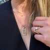 Georgetown Visitation Gate Pendant shown on figure in gold on Link Chain with Emerald Gemstone and Emerald Necklace