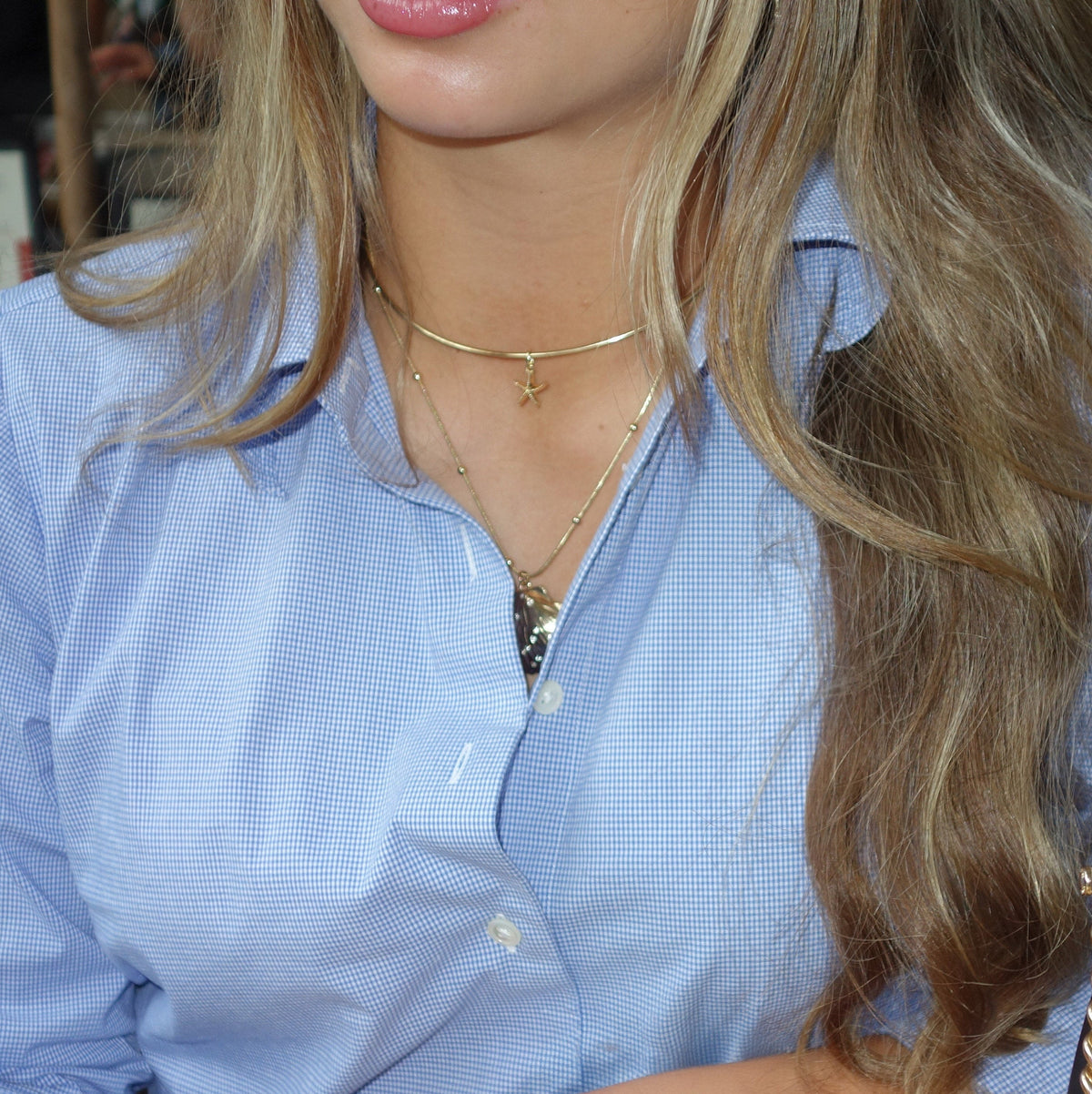 Starfish Charm shown on figure in gold on Neck Collar