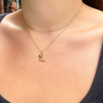 Junior League Letter Charm shown on figure in gold with Cable Chain and Garnet Gemstone, layered with Link Chain Choker