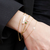 Kappa Delta Bracelet Bundle shown on figure in gold with Emerald Gemstone Bracelet