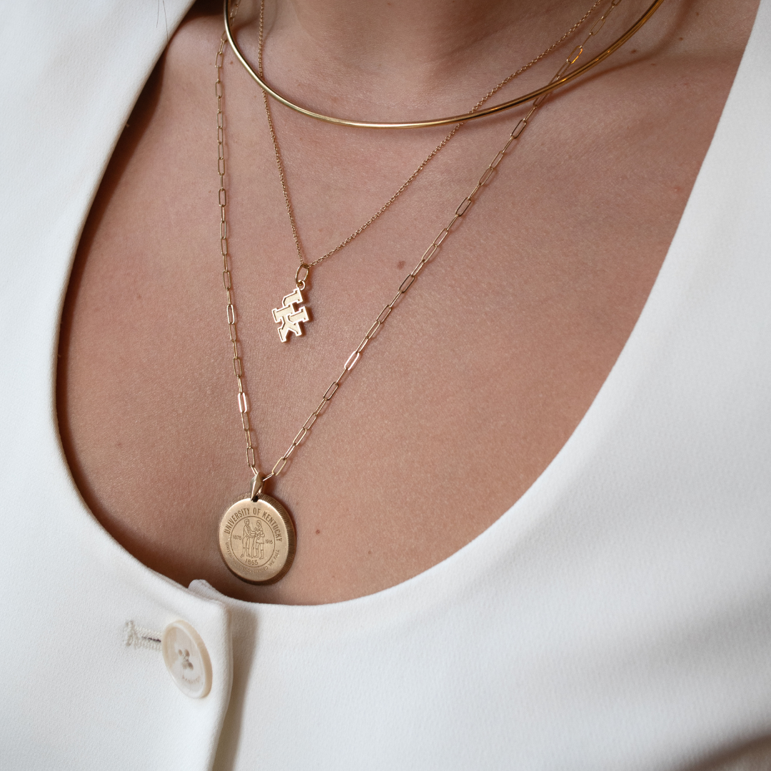 Kentucky Logo Charm shown on figure in gold on short Cable Chain with Kentucky Large Florentine Pendant on long Link Chain in gold with Neck Collar