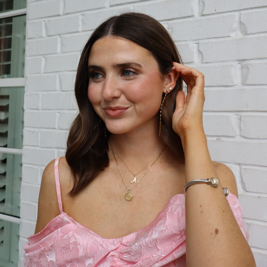 Alabama Logo Charm shown on figure in gold on Cable Chain with Alabama Sunburst Pendant on Link Chain