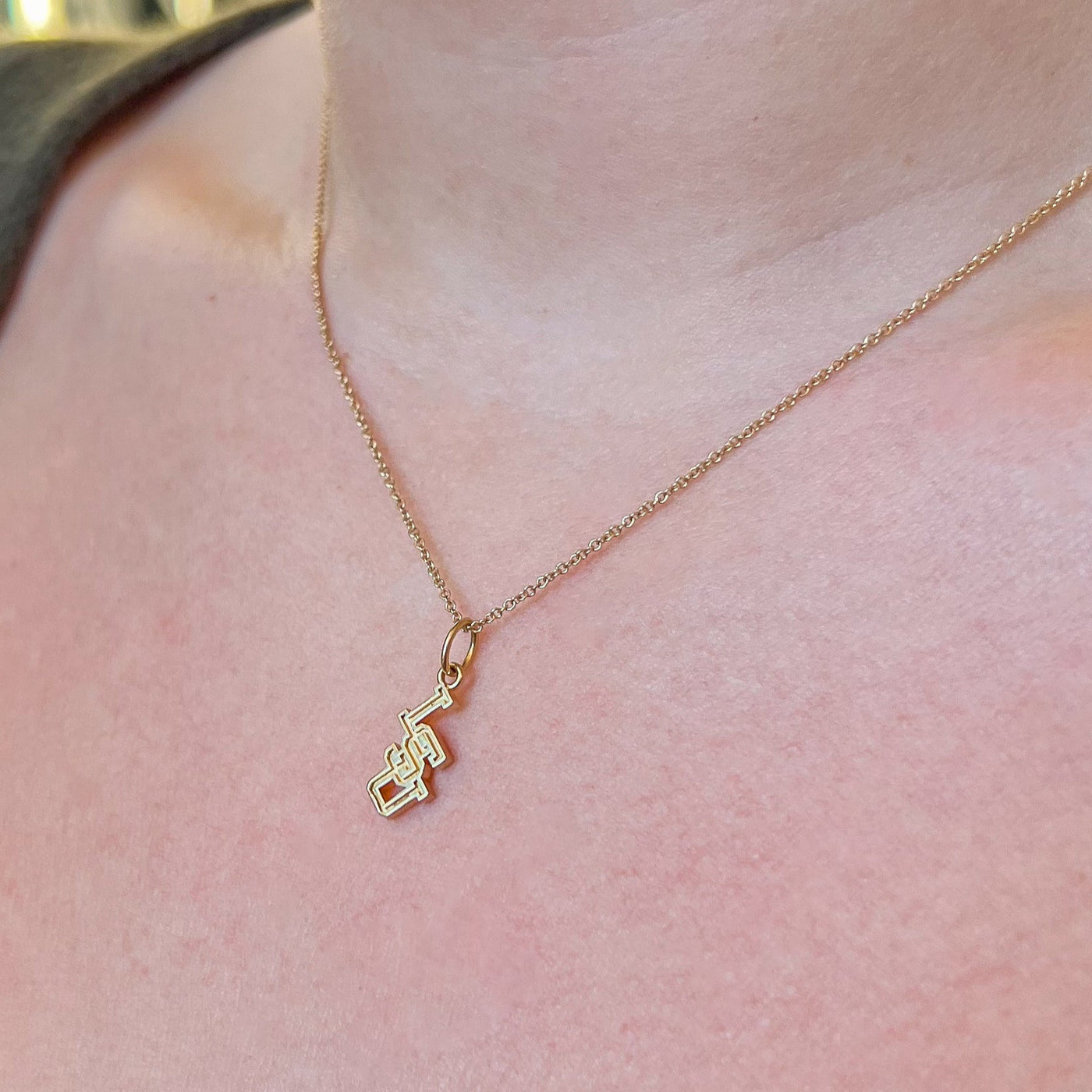 LSU Letter Charm shown on figure in gold on Cable Chain