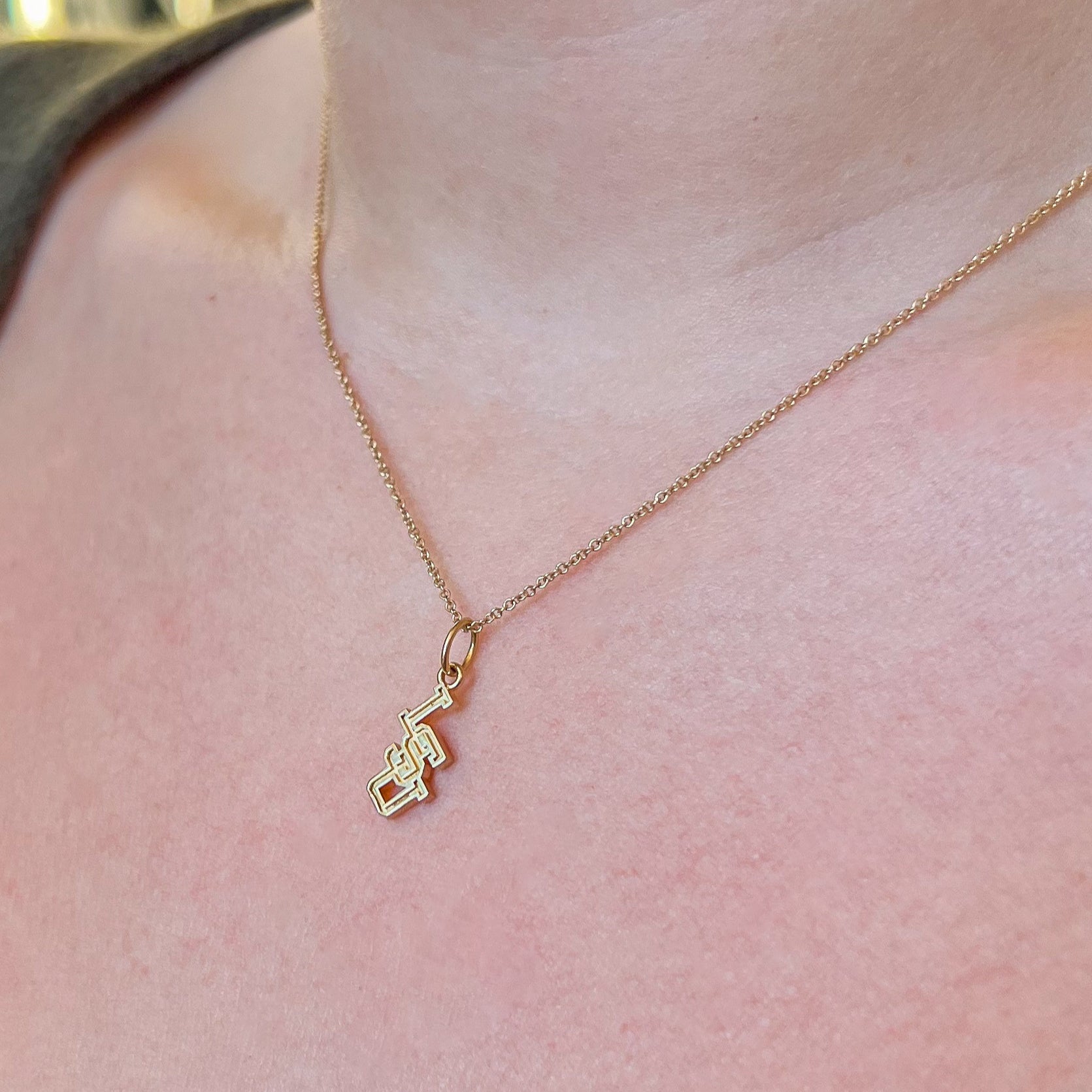LSU Letter Charm shown on figure in gold on Cable Chain