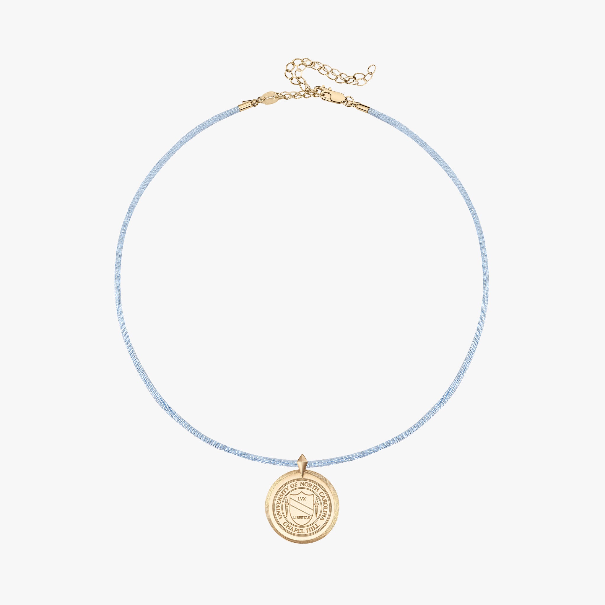 A delicate light blue cord necklace with a gold-toned circular pendant and extension chain, displayed on a clean off-white background.
