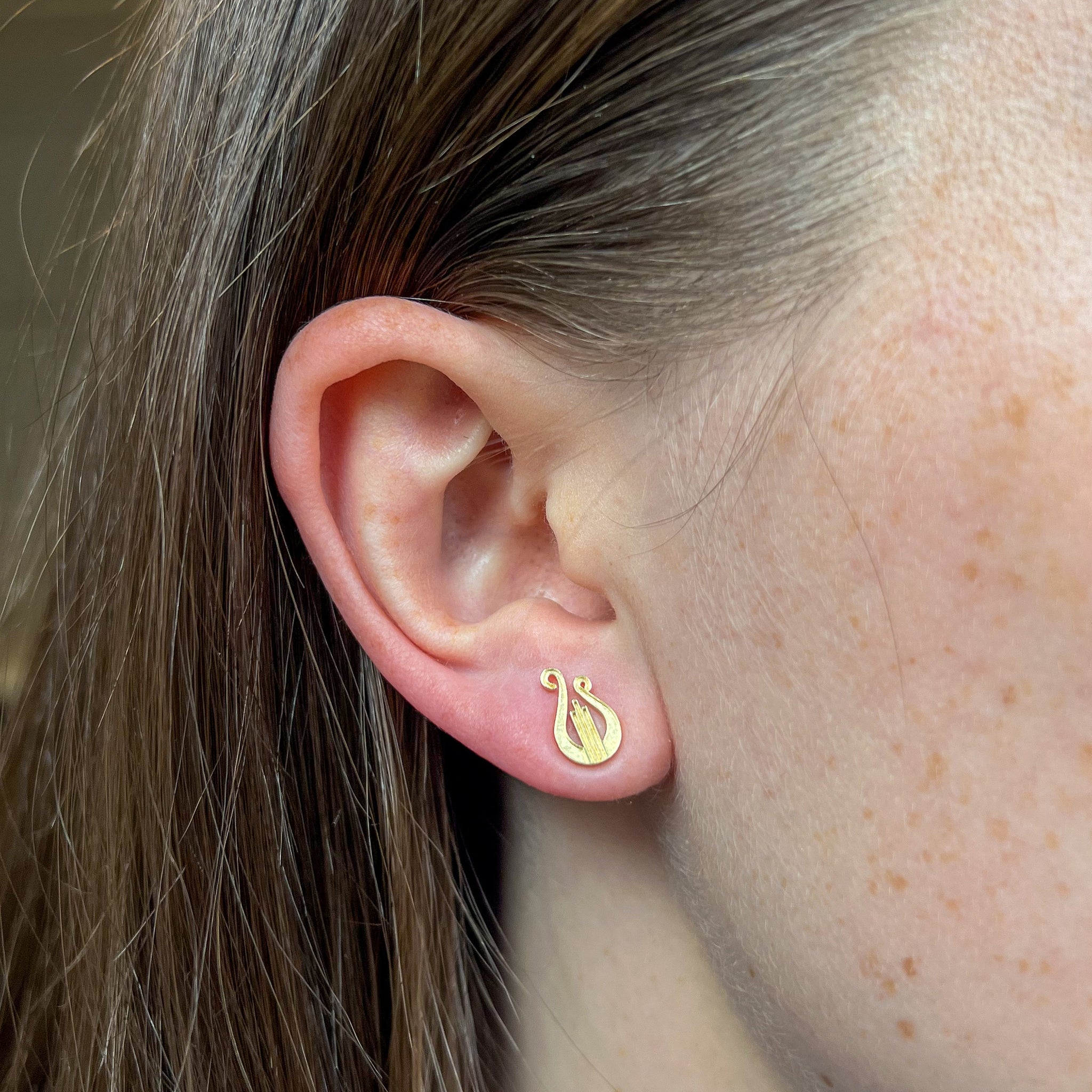 Alpha Chi Omega Lyre Stud Earring shown on figure in gold