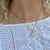 Michigan Go Blue Horizontal Bar Necklace shown on figure in gold with Link Chain Choker and Michigan Sunburst Pendant on Cable Chain