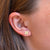 Nebraska Logo Stud Earring shown on figure in gold