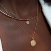 North Star Disc Charm shown on figure in gold on Neck Collar with UGA Sunburst Pendant on Cable Chain