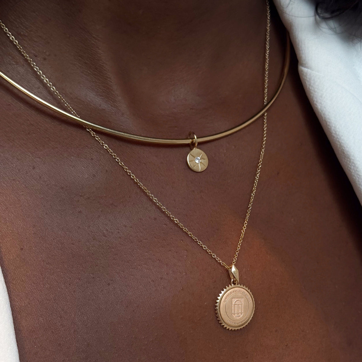 North Star Disc Charm shown on figure in gold on Neck Collar with UGA Sunburst Pendant on Cable Chain
