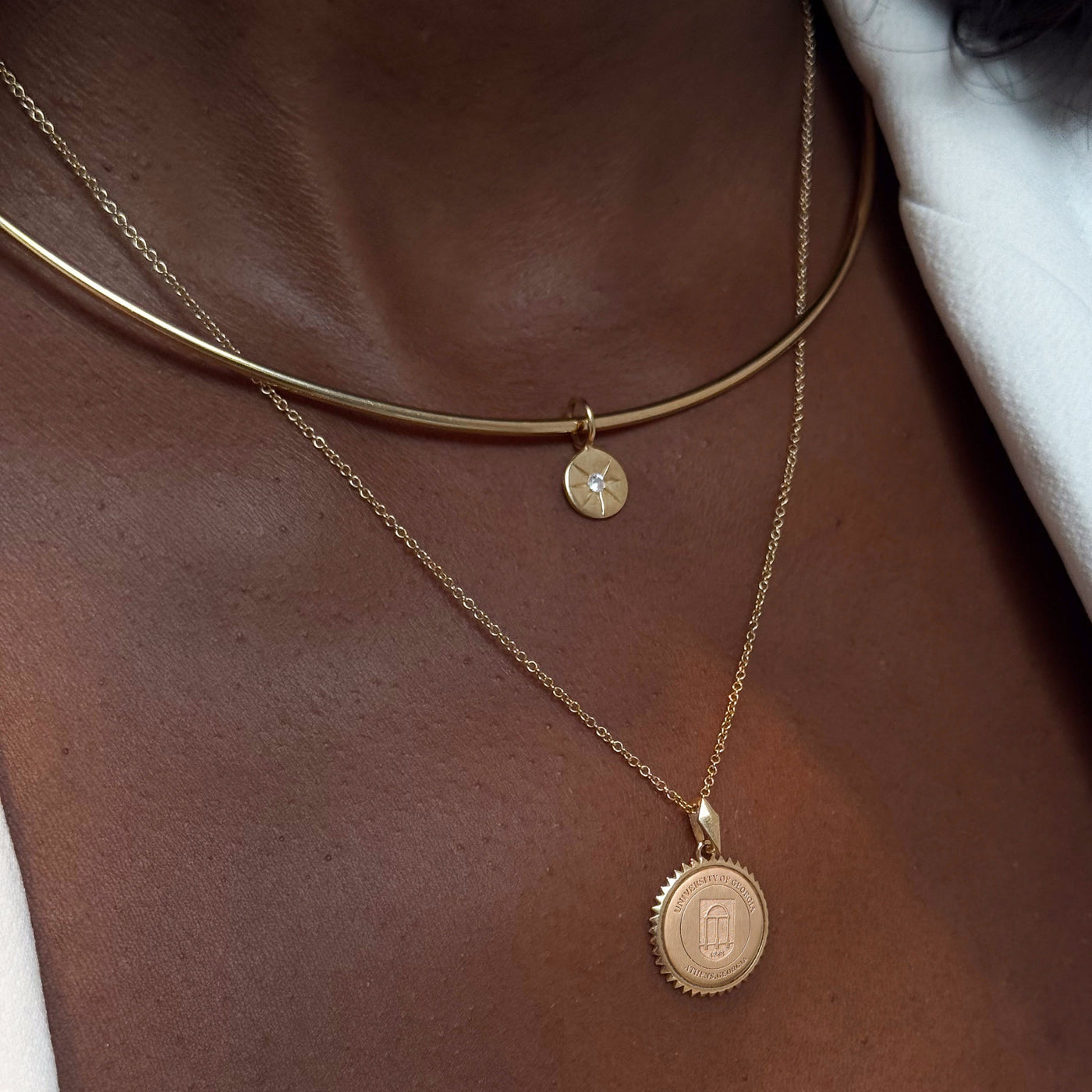 North Star Disc Charm shown on figure in gold on Neck Collar with UGA Sunburst Pendant on Cable Chain