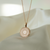 Ole Miss Eye Seal Sunburst Pendant shown in Cavan Gold with Cable Chain and silk background