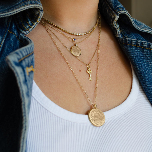 SMU Seal Florentine Pendant shown on figure in gold on Link Chain with KKG Key Charm and SMU Seal 7-Point Necklace