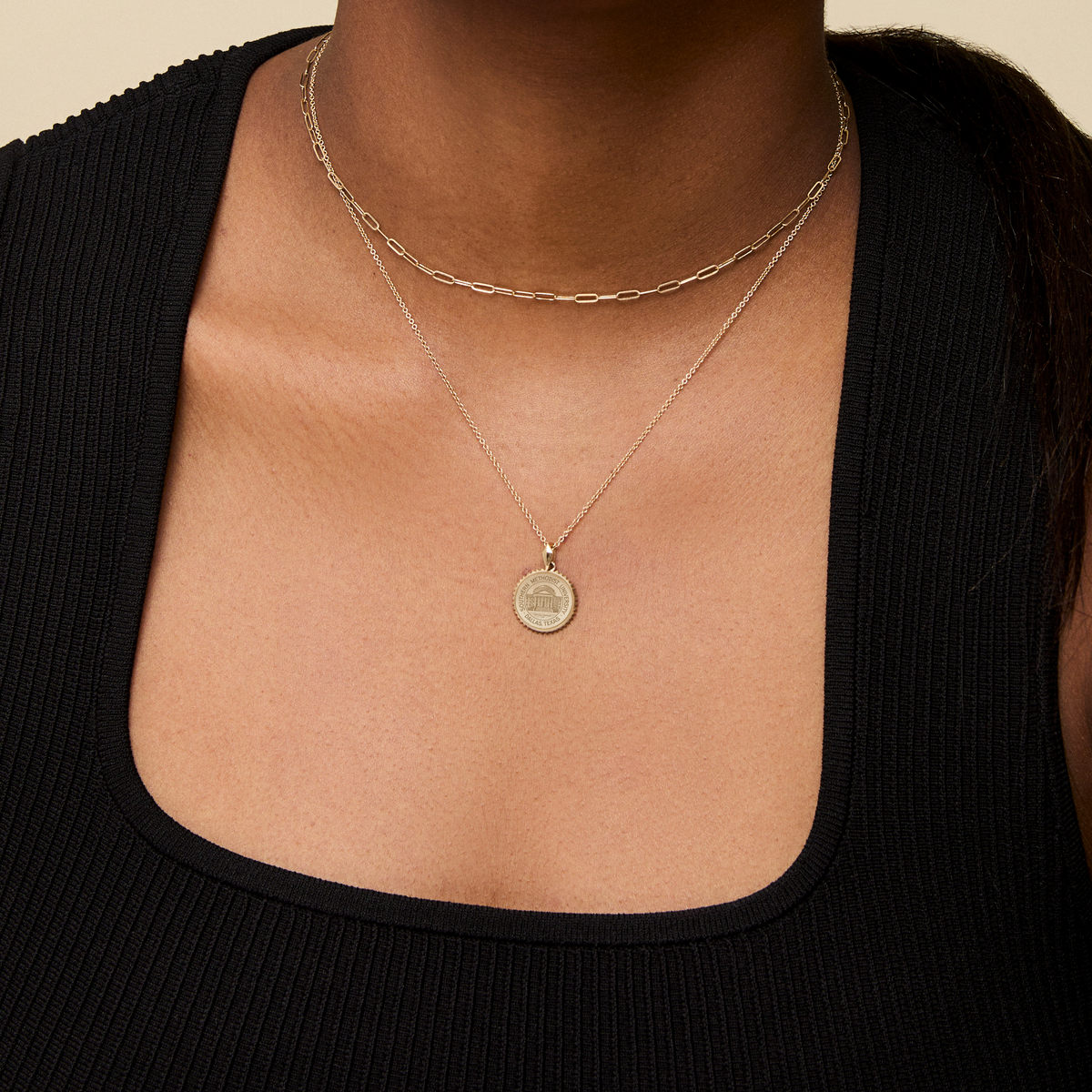 SMU Seal Sunburst Pendant shown on figure in gold on Cable Chain with Link Chain Choker