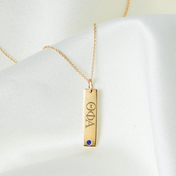 Theta Pi Alpha Sapphire Gemstone Bar laydown shown in gold on cable chain