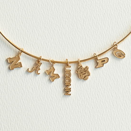Gold necklace with letter pendants on a white background
