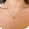 Emerald Shamrock Charm shown on figure in gold on Cable Chain
