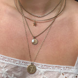 Pearl Charm shown on figure on Sunburst Pendant with Starfish Charm on Neck Collar
