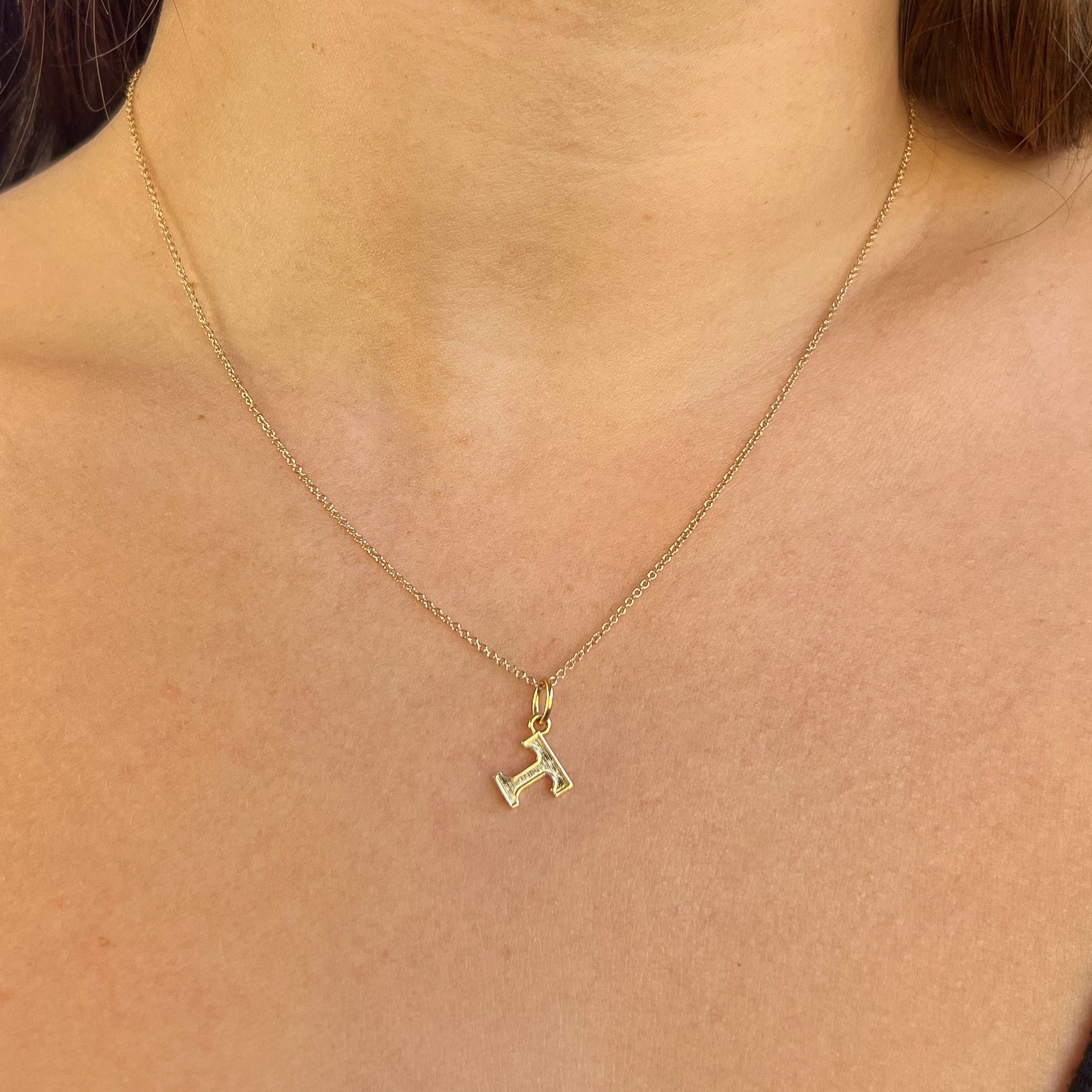 Tennessee T Charm shown on figure in gold on Cable Chain