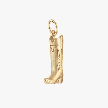 A small gold cowboy boot charm pendant with engraved decorative details, shown on a plain light gray background.
