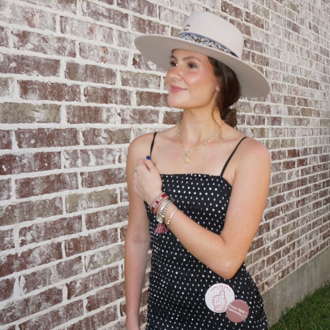 Texas A&M Sunburst Pendant shown on figure in gold