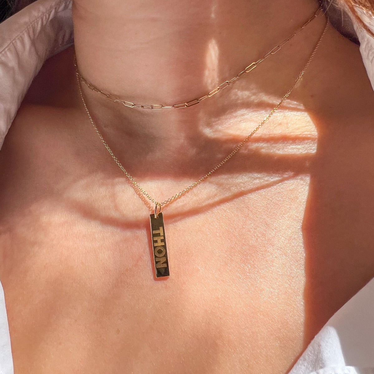 Penn State THON Vertical Layering Bar shown on figure in gold with Cable Chain and Link Chain Choker