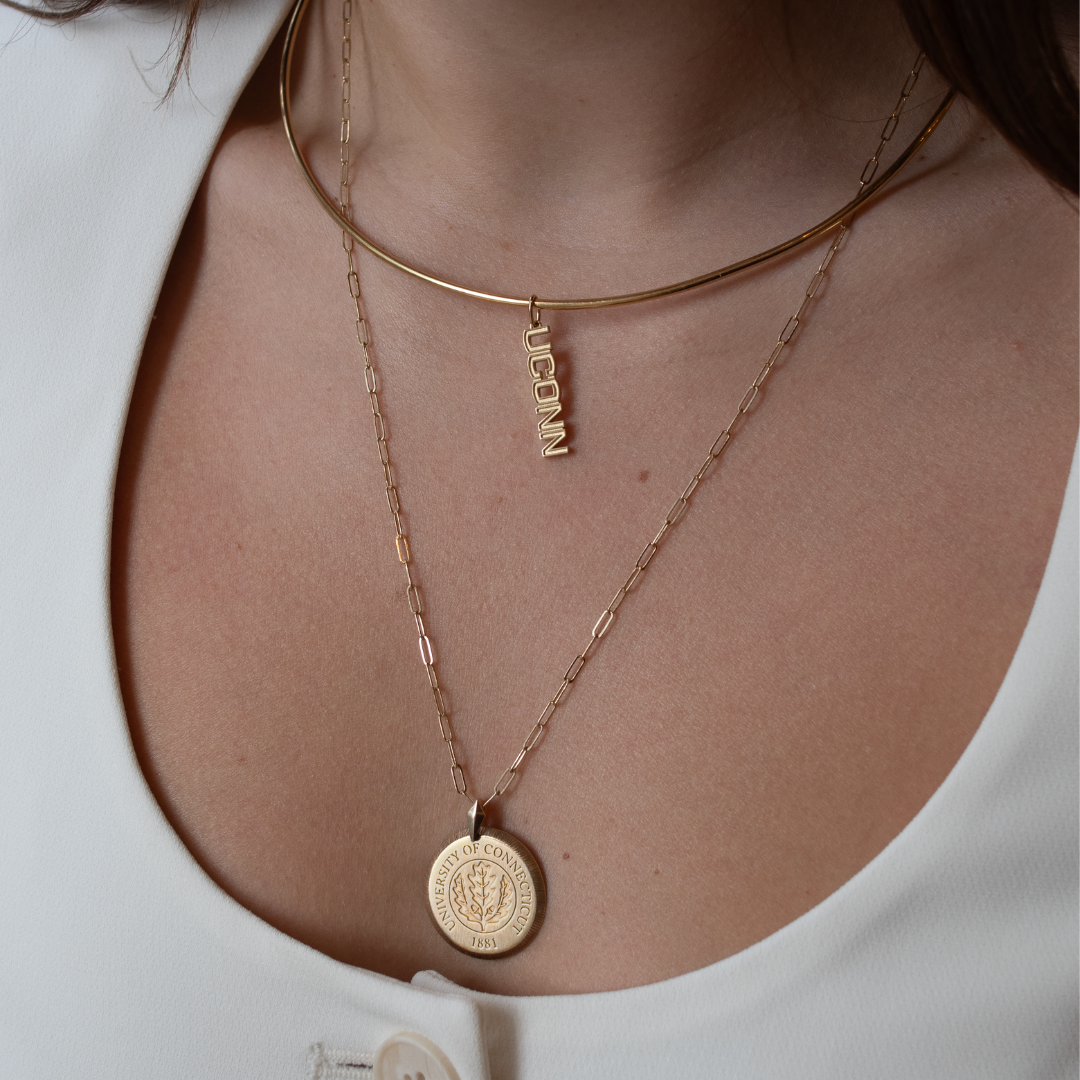 UConn Logo Charm shown on figure in gold on Neck Collar with UConn Large Florentine Pendant in gold on Link Chain